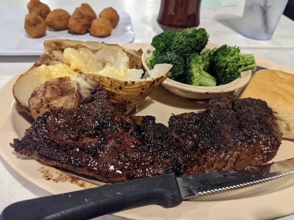 10z Rib Eye with Breaded Mushrooms Baked Potato Steamed Broccoli and Roll